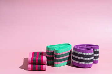 Different resistance  booty bands  on pink background  for  gluten exercises