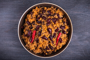 Spanish, Mexican tomato spicy rice with beans in a plate, close-up, top view