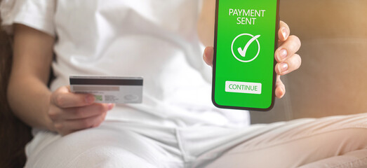 Banner online money transfer confirmed background photo, woman sitting on sofa at home and shopping online