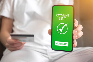 Online money transfer confirmed background photo, woman sitting on sofa at home and shopping online photo