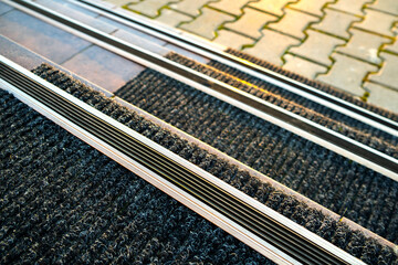 Closeup of ceramic tiles covering porch stairs with rubber anti slippery stripes on it.