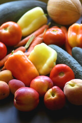 Various colorful summer fruit and vegetable on dark background. Selective focus.