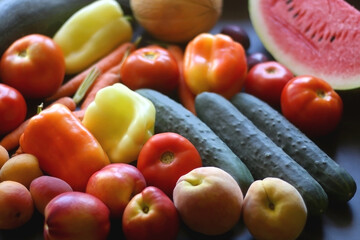 Various colorful summer fruit and vegetable on dark background. Selective focus.