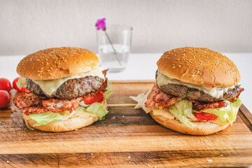 Homemade hamburger on a wooden board. Fresh juicy big burger.