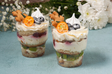 desserts in plastic cups with cream and chocolate