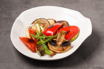 eggplant, zucchini, pepper, and grilled mushrooms on a white plate