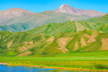 Grassland and river with mountain natural landscape in Xinjiang.