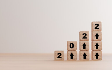 2022 year and rise up arrow print screen on wooden cube block and copy space for preparation.start...