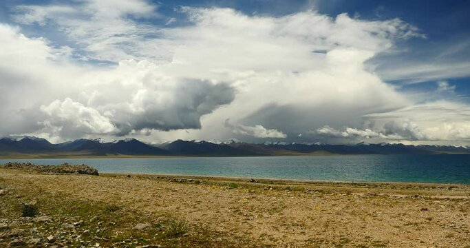 4k time lapse of huge clouds mass rolling over lake namtso & Tanggula snow mountain peak,tibet mansarovar,Tibet's second largest lake,is the third largest saltwater lake in China.Danggula(Tanggula) Mo