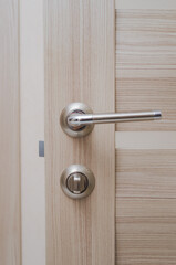 wooden door with metal handle and lock