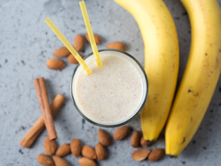 Milk smoothie cocktail for breakfast with banana, almonds and cinnamon