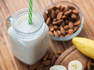 Milk smoothie cocktail for breakfast with banana, almonds and cinnamon