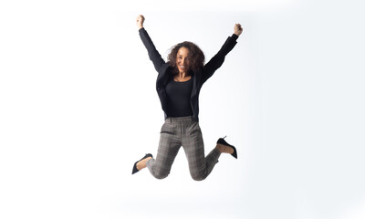 beautiful young hispanic woman jumping and smiling afro hairstyle isolated on white background