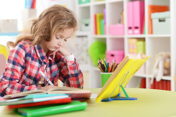 Close up portrait of little girl doing homework