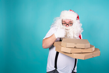Funny Santa Claus is eating pizza. Hungry man.