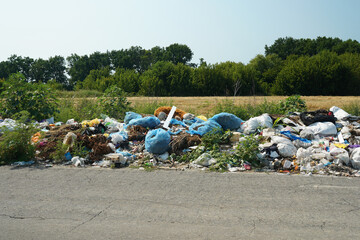 illegal rubbish dump near the road, garbage in the nature