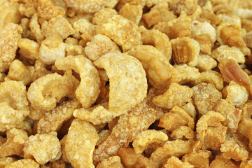Close up of pork snack or pork scratching at market, crispy fried pork skin and blistered is traditional food in the north of Thailand.