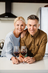 Smiling middle aged couple standing together