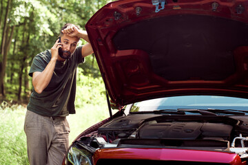  Man with a car problem using the phone for help
