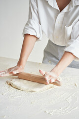 the chef rolls the dough cooking flour product in the kitchen