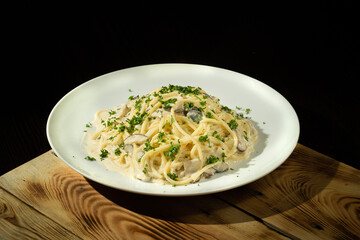 Close-up setting shot of a dish of Linguine Carbonara spaghetti