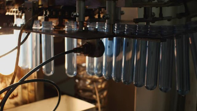 The blue preforms are sent to the bottle blowing machine. Plant for the production of drinking and mineral water