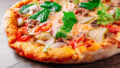 Pizza with Mozzarella cheese, Bolognese sauce, minced meat, bacon, tomato and vegetables. Italian pizza on wooden background.