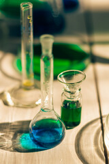 Chemical laboratory dishes with multicolored solutions on a white table in the laboratory.Back to school concept.Young scientists.Natural sciences.Preschool and school education of children.