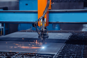 CNC plasma cutting metal iron material with sparks, industry background
