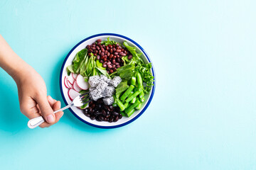 Healthy vegan salad vegetables with lettuce, corn salad, radish, kidney bean, azuki bean and green...