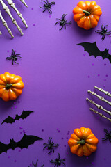 Happy Halloween poster mockup. Flat lay bony hands, pumpkins, bats silhouettes on purple...