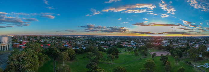 Panoramic Aerial Drone view of Suburban Sydney housing, roof tops, the streets and the parks NSW Australia
