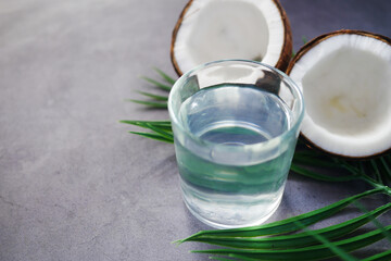 Fototapeta na wymiar slice of fresh coconut and glass of coconut water on table 