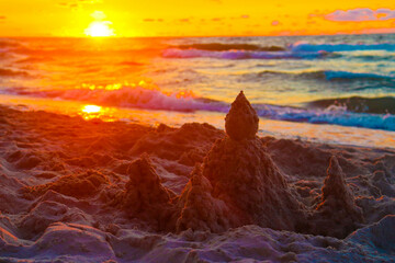 Beautiful sand castle, scenic sunset at the beach.