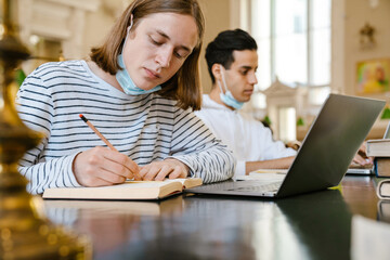 Two students wearing protective medical masks