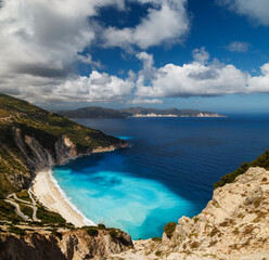 A top panoramic view at Myrtos Beach and fantastic turquoise and blue Ionian Sea water. Aerial view, summer scenery of famous and extremely popular travel destination in Cephalonia, Greece, Europe.