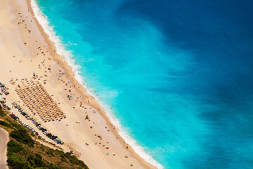 Fototapeta na wymiar Top view at Myrtos Beach with turquoise and blue Ionian Sea water. Summer scenery of famous and extremely popular travel destination in Cephalonia, Greece, Europe.