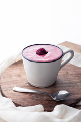 Freshly made cherry smoothie in white ceramic mug. Food photography