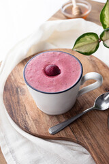 Freshly made cherry smoothie in white ceramic mug. Food photography