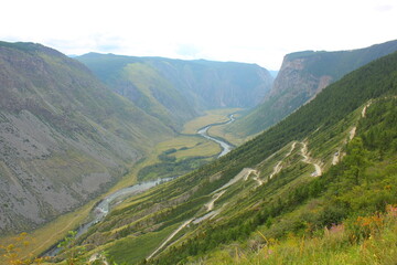 Fototapeta premium winding descent from the mountain to the river valley