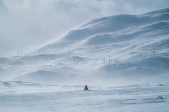 Snowmobile driving trough Scandinavian Winter