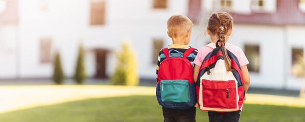 Children with backpacks going to the school