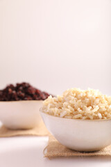 Organic boiled brown rice on bowl isolated in white background