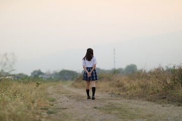 Obraz premium beautiful asian japanese school girl uniform looking at park outdoor
