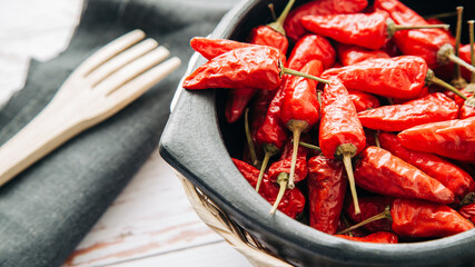 red chili in a small bowl, isolated on white background, view from front and top