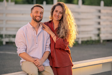 Fototapeta premium Happy young couple in casualwear enjoying sunny day in the countryside