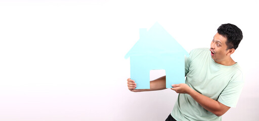 Asian man holding paper home shape presenting isolated on white background in studio With copy space.