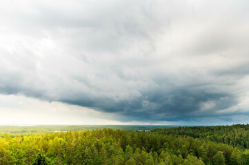 Storm with dark rain clouds over the Swedish forest and lakes at the Aboda Klint viewpoint in...