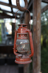 Old vintage pendant metal lamp, covered with dust. Hanging outdoors