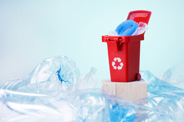 Red Plastic Recycling Can On Top Of Single-Use Plastic Cups And Bottles.